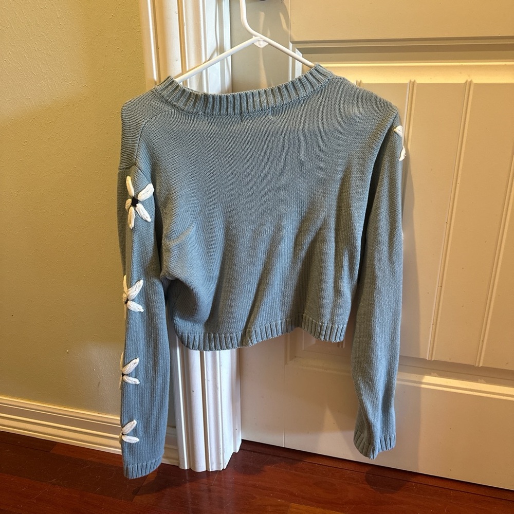 Blue Sweater with White Floral Accents